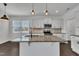 Bright open concept kitchen with stainless steel appliances, granite countertops, and modern island at 384 Grey Hawk Dr, Garner, NC 27529