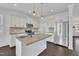 Kitchen featuring stainless steel appliances, granite countertops, and island with pendant lighting at 384 Grey Hawk Dr, Garner, NC 27529
