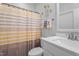 The bathroom features a white vanity, striped shower curtain, and decorative accents at 412 Kavanaugh Rd, Wake Forest, NC 27587