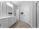 Bathroom featuring white cabinets, an open doorway, and a bright neutral palette at 412 Kavanaugh Rd, Wake Forest, NC 27587