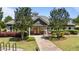 Inviting clubhouse entrance with double doors, surrounded by lush landscaping at 412 Kavanaugh Rd, Wake Forest, NC 27587
