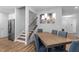 Dining room showcases a rustic table setting with a modern chandelier at 412 Kavanaugh Rd, Wake Forest, NC 27587