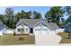 Beautiful one-story home featuring an attached three-car garage and large driveway at 412 Kavanaugh Rd, Wake Forest, NC 27587