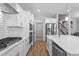 Modern kitchen featuring white cabinetry, quartz countertops, and stainless steel appliances at 412 Kavanaugh Rd, Wake Forest, NC 27587
