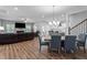Open-concept living room with fireplace, wood floors, and a view into kitchen and dining area at 412 Kavanaugh Rd, Wake Forest, NC 27587