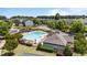 Aerial view of the community pool with ample seating, a clubhouse, and a playground nearby at 412 Kavanaugh Rd, Wake Forest, NC 27587