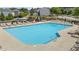 Community pool with a large swimming area, plenty of deck chairs, and beautiful landscaping at 412 Kavanaugh Rd, Wake Forest, NC 27587