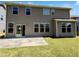 Backyard with sliding glass door, small concrete patio, and grassy area perfect for outdoor activities at 4169 Weavers Pond Dr, Zebulon, NC 27597