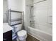 Bright bathroom with a shower-tub combo and sleek metal shelving at 4169 Weavers Pond Dr, Zebulon, NC 27597