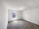 Clean, carpeted bedroom with a window providing natural light and an overhead light fixture at 4169 Weavers Pond Dr, Zebulon, NC 27597