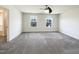 Spacious room features carpeted floor with natural light and large windows for views at 4169 Weavers Pond Dr, Zebulon, NC 27597