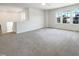 Bright bonus room features carpeted floor and large windows offering neighborhood views at 4169 Weavers Pond Dr, Zebulon, NC 27597