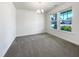 Bright dining room boasts large windows and neutral carpet at 4169 Weavers Pond Dr, Zebulon, NC 27597