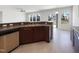 Kitchen featuring stainless steel dishwasher, sink, and brown cabinets at 4169 Weavers Pond Dr, Zebulon, NC 27597