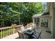Spacious wooden back deck with outdoor seating and a table for dining at 4608 Regency Dr, Durham, NC 27713