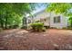 Exterior view of a well-maintained backyard with a wooden deck, lush greenery, and ample space for outdoor activities at 4608 Regency Dr, Durham, NC 27713