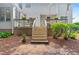 Backyard stairs lead to a deck with privacy lattice and backyard plants and bushes at 4608 Regency Dr, Durham, NC 27713