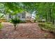 An expansive backyard with lush greenery, wooden deck, and mature trees providing a private outdoor retreat at 4608 Regency Dr, Durham, NC 27713