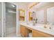 Bathroom with double sinks, vanity, mirror, lighting, and built-in towel racks and storage at 4608 Regency Dr, Durham, NC 27713