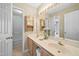 Bright bathroom with double sink vanity, and a walk-in shower visible through the doorway at 4608 Regency Dr, Durham, NC 27713