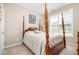 Bedroom with wood bed, carpeted floors, natural light from a window, and light, neutral walls at 4608 Regency Dr, Durham, NC 27713