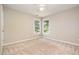 Bedroom with carpeted floors, natural light from a window, a ceiling fan, and light, neutral walls at 4608 Regency Dr, Durham, NC 27713