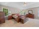 Spacious bedroom suite with trey ceiling, neutral walls, carpet, and dark wood furniture at 4608 Regency Dr, Durham, NC 27713