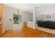 Well-lit dining area featuring gleaming hardwood floors, a stylish chandelier, and convenient access to both the deck and living room at 4608 Regency Dr, Durham, NC 27713