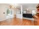 Dining area with hardwood floors leading to a living room, adjacent to an outdoor patio space at 4608 Regency Dr, Durham, NC 27713