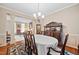 Formal dining room with detailed trim, hardwood floors, buffet and view to the living room at 4608 Regency Dr, Durham, NC 27713