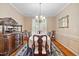 Bright dining room with detailed trim, hardwood floors, buffet and view to the living room at 4608 Regency Dr, Durham, NC 27713