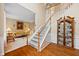 Inviting foyer with hardwood floors, a staircase with carpet, and a cabinet; the living room is to the left at 4608 Regency Dr, Durham, NC 27713