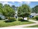 Charming two-story home with lush green lawn, mature trees, and a welcoming front porch in a Gathering-friendly neighborhood at 4608 Regency Dr, Durham, NC 27713