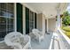 Cozy front porch with two white rocking chairs and hanging flower baskets create a welcoming ambiance at 4608 Regency Dr, Durham, NC 27713