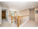 Bright hallway with a staircase, railing, chandelier, and access to the other rooms in the house at 4608 Regency Dr, Durham, NC 27713