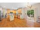 A bright kitchen featuring wood cabinets, granite countertops, stainless steel appliances, and seamless access to the deck at 4608 Regency Dr, Durham, NC 27713