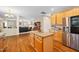 Open concept kitchen with island, stainless steel appliances, granite countertops and hardwood floors at 4608 Regency Dr, Durham, NC 27713