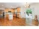 Open-concept kitchen with natural light, wood floors, stainless steel appliances, and access to outdoor patio at 4608 Regency Dr, Durham, NC 27713