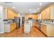 Bright kitchen featuring light wood cabinets, stainless steel appliances, and an island, perfect for cooking at 4608 Regency Dr, Durham, NC 27713