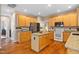 Spacious kitchen featuring an island, wood cabinets, granite counters, and stainless steel appliances at 4608 Regency Dr, Durham, NC 27713