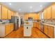 Kitchen featuring a center island, wood cabinets, stainless steel appliances, and granite countertops at 4608 Regency Dr, Durham, NC 27713