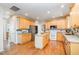 Well-lit kitchen offers wooden floors, light cabinets, granite countertops, and a functional center island at 4608 Regency Dr, Durham, NC 27713