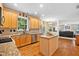 Spacious kitchen featuring an island, stainless steel appliances, granite countertops, and hardwood floors at 4608 Regency Dr, Durham, NC 27713