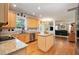 Spacious kitchen with wood floors, stainless steel appliances, granite countertops, and access to an outdoor area at 4608 Regency Dr, Durham, NC 27713