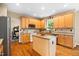 Charming kitchen with granite counters, center island, wood cabinets, and stainless steel appliances at 4608 Regency Dr, Durham, NC 27713