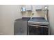 Functional laundry room with washer, dryer, wire shelves, and storage space at 4608 Regency Dr, Durham, NC 27713
