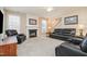 Cozy living room featuring a fireplace, neutral paint, plush carpeting, and comfortable leather seating at 4608 Regency Dr, Durham, NC 27713