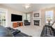 Spacious living room with a fireplace, plush carpeting, and comfortable leather seating at 4608 Regency Dr, Durham, NC 27713