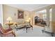 Comfortable living room with patterned sofa, vintage furnishings, and an open view to the dining area at 4608 Regency Dr, Durham, NC 27713