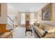 A brightly lit living room showcases a staircase, a comfortable sofa, and traditional decor at 4608 Regency Dr, Durham, NC 27713